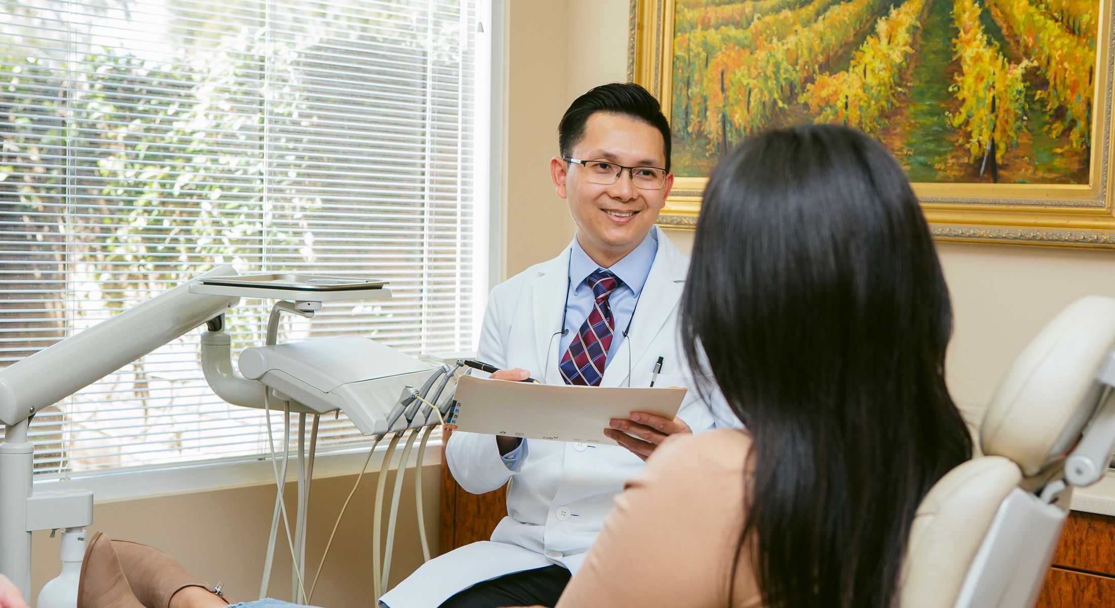 Newport Beach Cosmetic Dentist Dr. Chau with patient